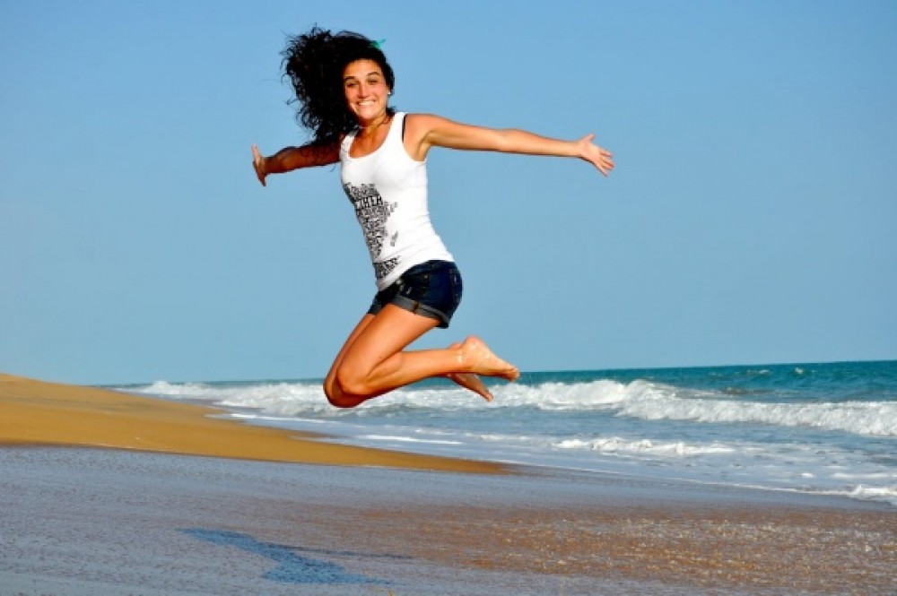 Woman jumping at beach